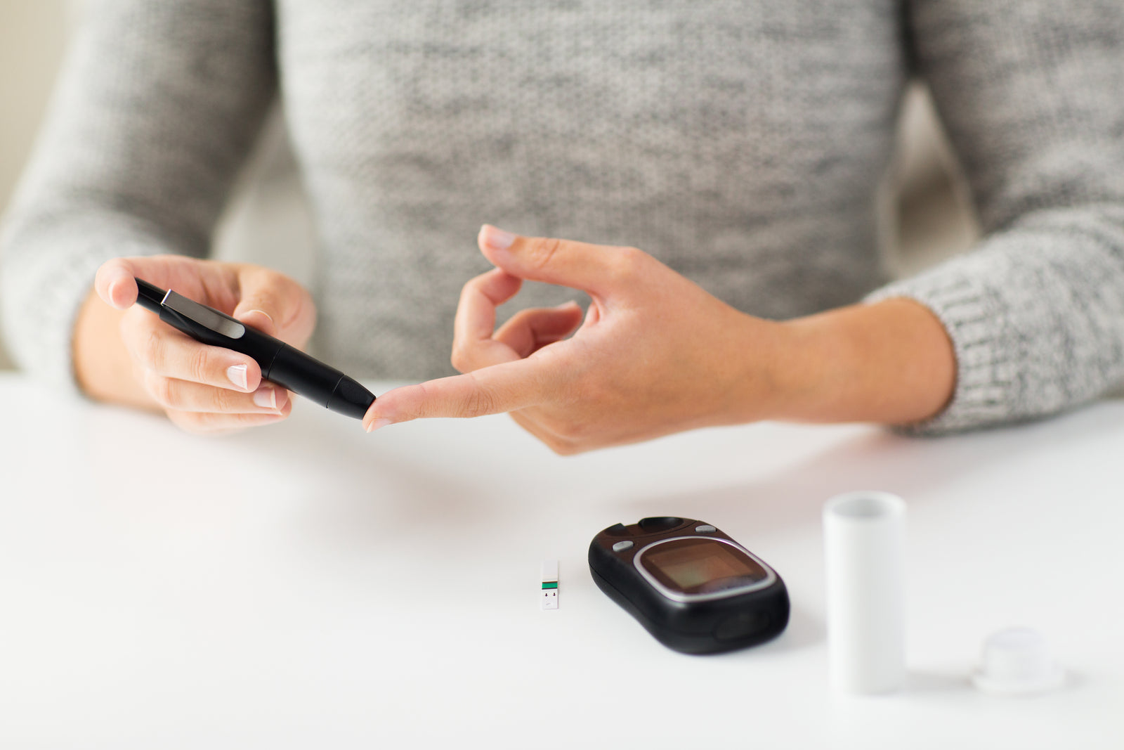Woman testing herself for her current insulin level.
