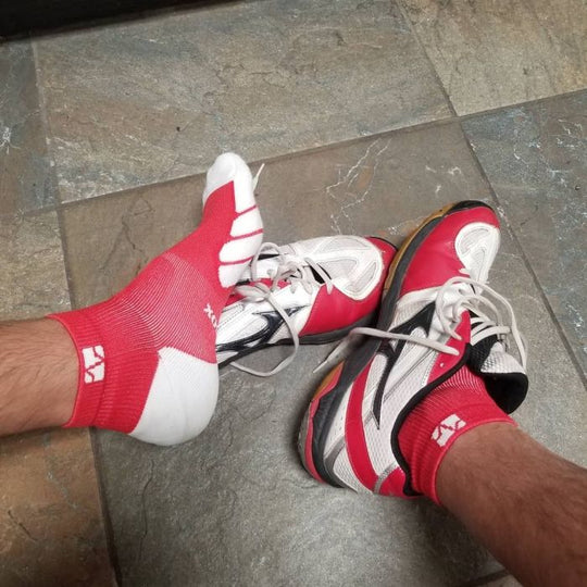 Athlete wearing red VitalSox socks.