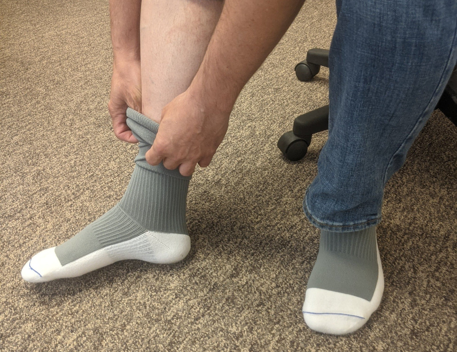 Man putting on compression socks.