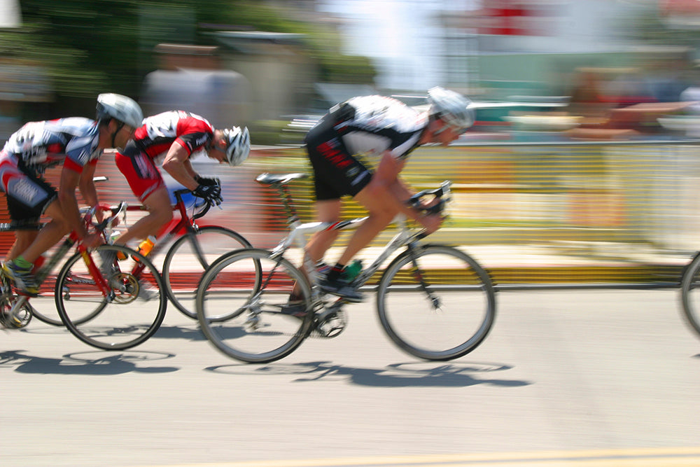 Cyclists racing and wearing compression socks for biking