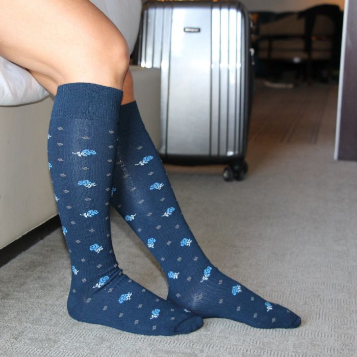 Athlete relaxing in their Sox Solution over the calf socks in blue.